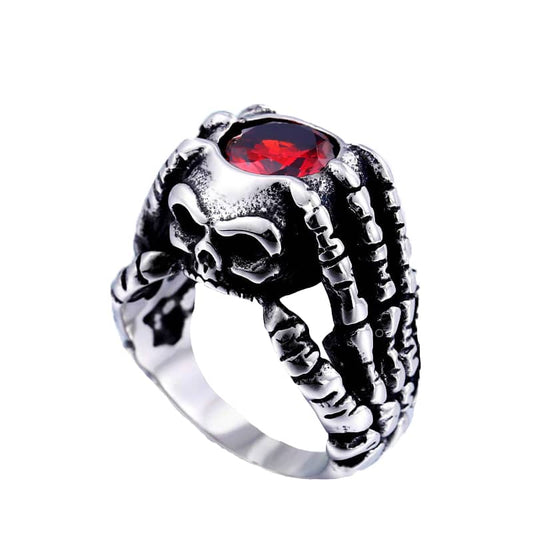 Bague gothique femme en acier avec crâne, main squelette et pierre rouge